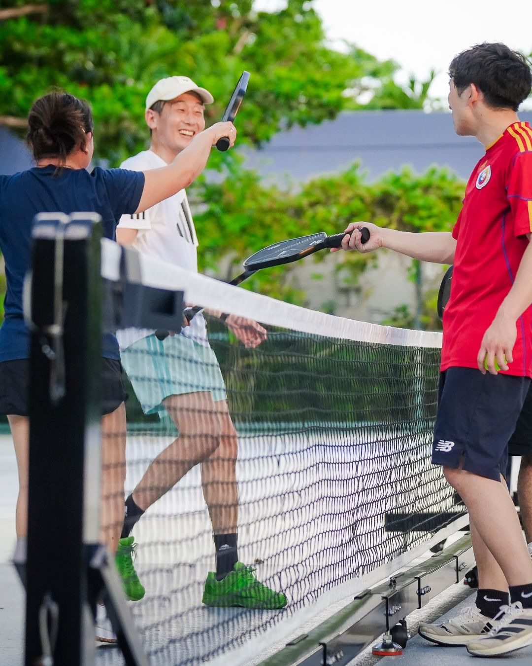 Pickleball players meeting at the net