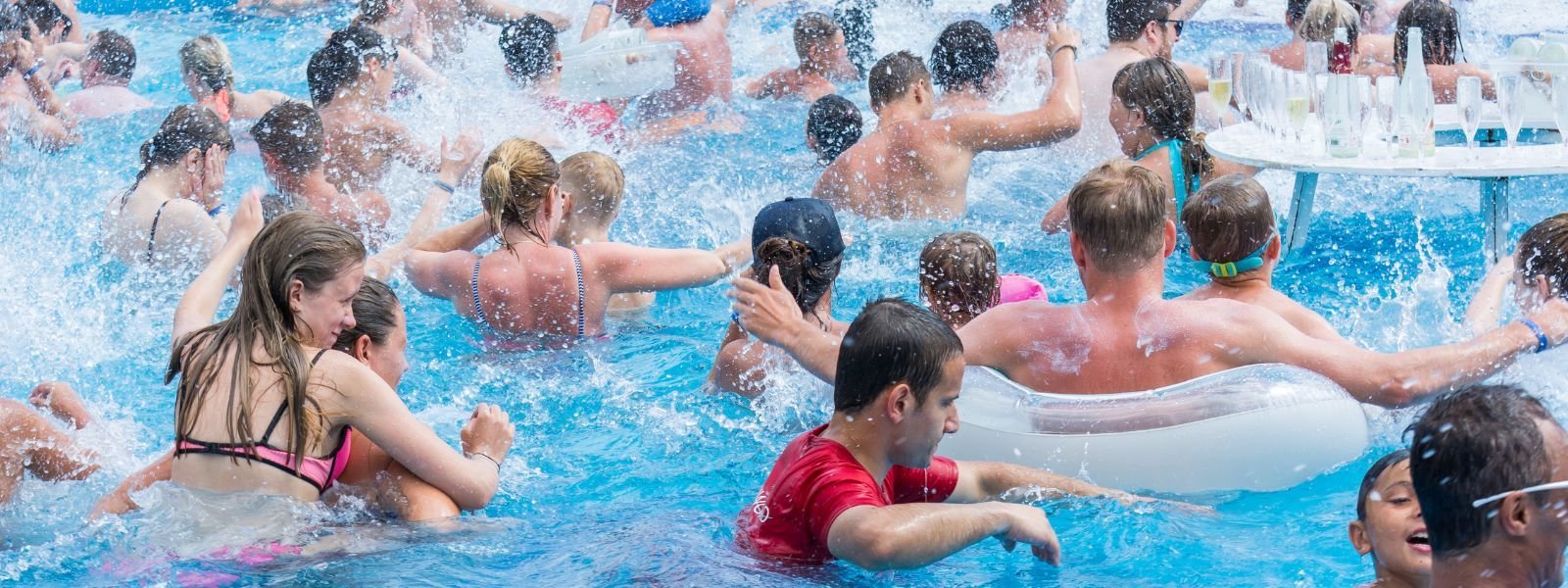 A jam-packed resort pool, guests shoulder to shoulder