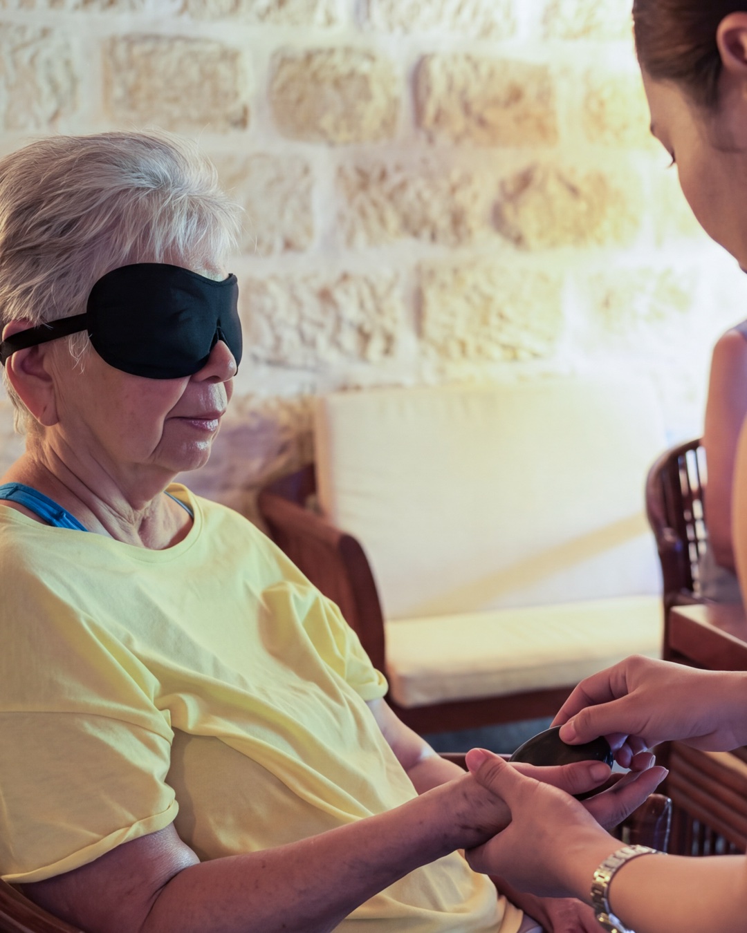 A blindfolded guest identifying figurines by touch