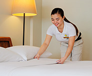 Housekeeping staff preparing a room