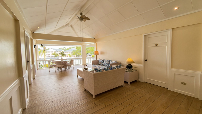 Beachside Two-Bedroom Suite living room opening onto a balcony with lagoon view