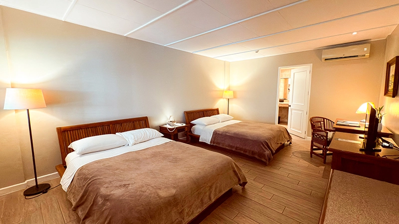 Two queen beds in the Deluxe Poolside Room
