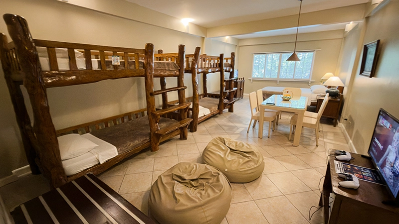 Friends-and-Family Room with log bunk beds, bean bags, dining table, and TV with game console