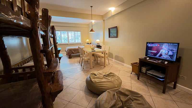 Friends-and-Family Room lounge with bean bags, TV, and game console