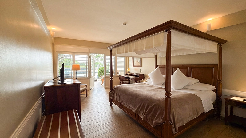 Canopied four-poster king bed in the Ground-Floor Beachside Room