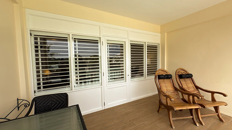 Upper-Floor Beachside Room covered balcony with plantation lounge chairs