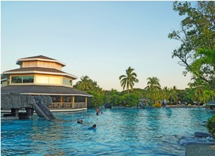 Swimmers in the lagoon beside the resort's poolside pavilion