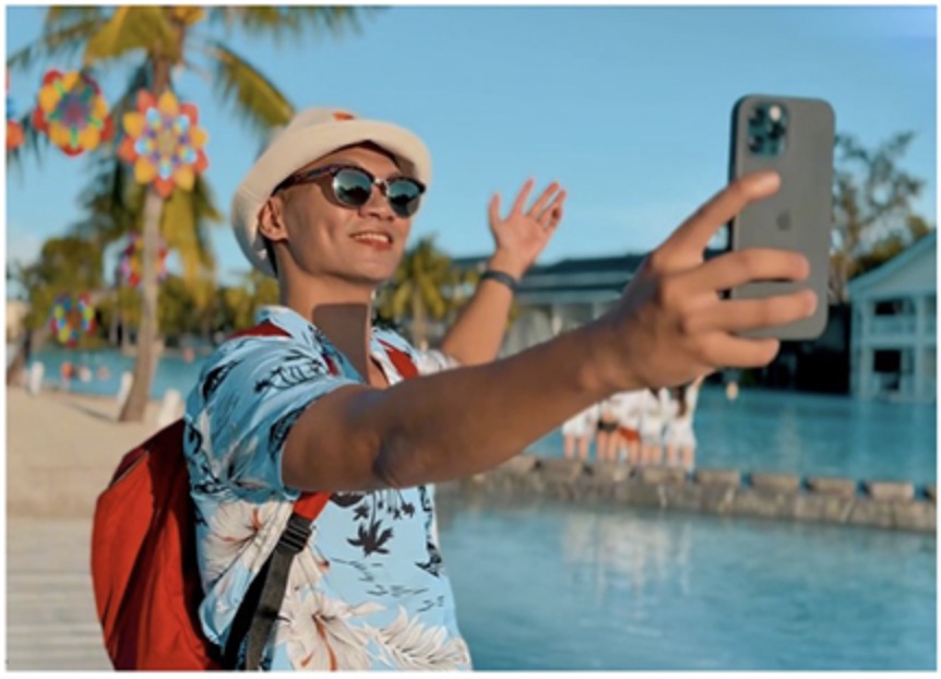 Guest taking a selfie on the boardwalk over the Plantation Bay lagoon